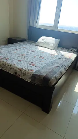 A king size bed with mattress at very affordable price.