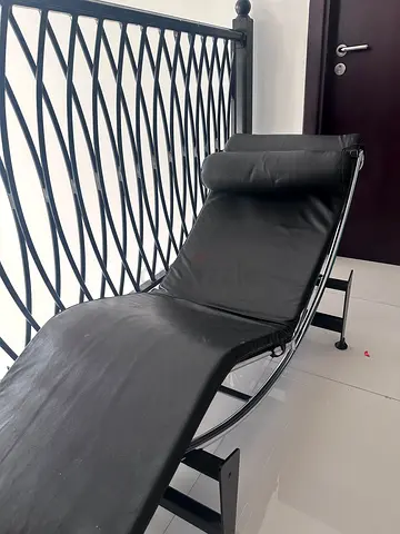 Black leather chaise lounge with metal frame from the one