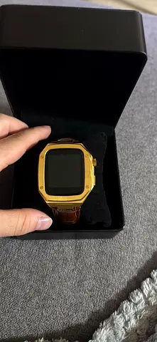 Gold-tone digital wristwatch with brown leather strap