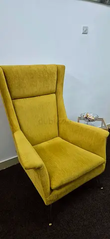 Reduced price. Comfortable mustard-yellow upholstered armchair with brass legs