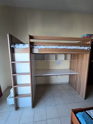 Wooden loft bunk bed with built-in desk and shelving