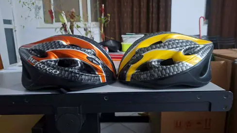 2 Aerogo bicycle helmets — yellow and orange