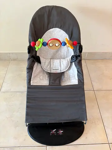 Baby bouncer / rocker seat in grey with 2 original toy bars - gently used
