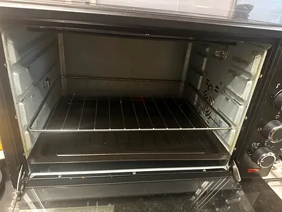 Used countertop electric oven with rotisserie and baking tray