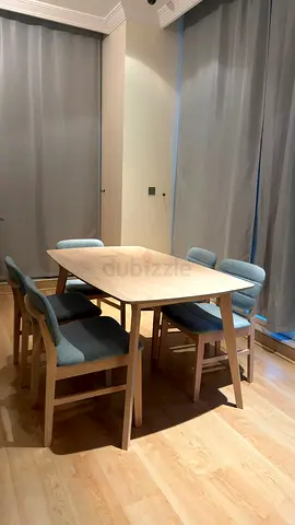 Light wood dining table with 4 upholstered chairs - good condition