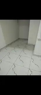 Studio for annual rent in Ajman, Al Rashidiya area, featuring a separate kitchen.