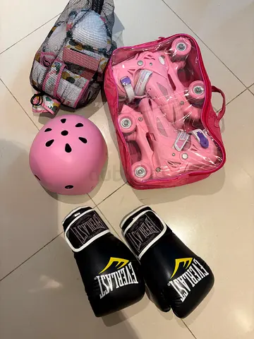 Kids pink quad roller skates with helmet and protective gear + boxing gloves