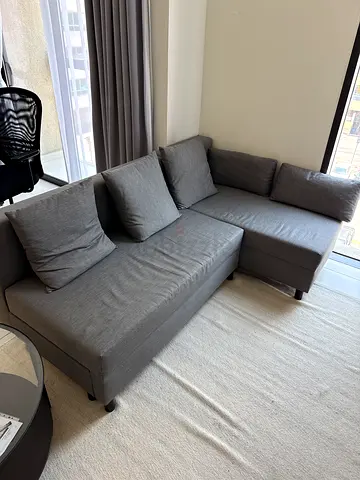 Grey L-shaped Sofa Bed with Cushions - Good Condition