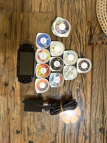 Sony PSP with 18 individual games, including $% Of War and FIFA 11