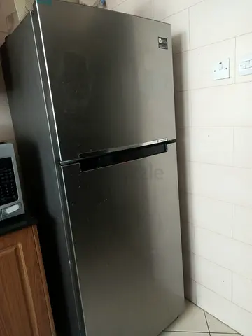 Stainless Steel Double-Door Refrigerator with Top Freezer - Good Condition