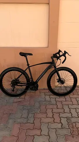 Sleek Black Road Bike with Drop Bars and Disc Brakes