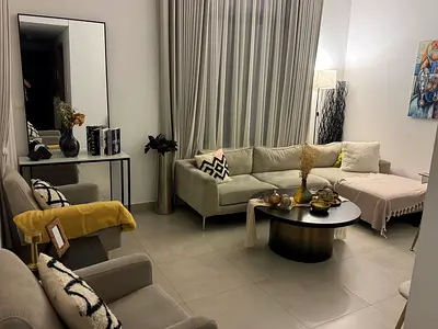 Light grey L-shaped sofa with coffee table and armchairs - excellent condition