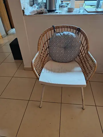 Rattan-style dining chair with cushion — good condition