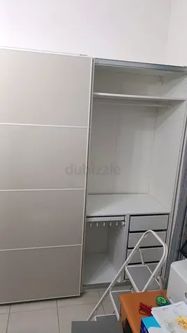 White sliding door wardrobe with shelves and drawers