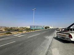 Land for sale in Al-Sajaa Industrial Estate, on two streets, 200,000 sqft