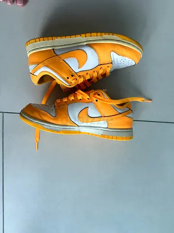Used yellow and white Nike Dunk Low sneakers, size approx. EU 2.5