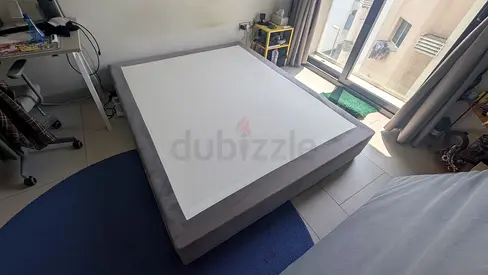 Queen-size upholstered platform bed frame in grey - good condition