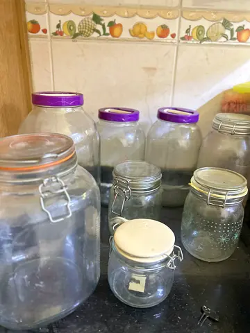 Set of assorted glass storage jars with lids (used)