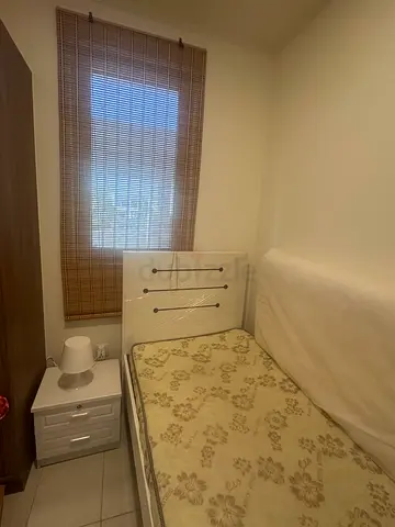 Single bed with mattress and side table