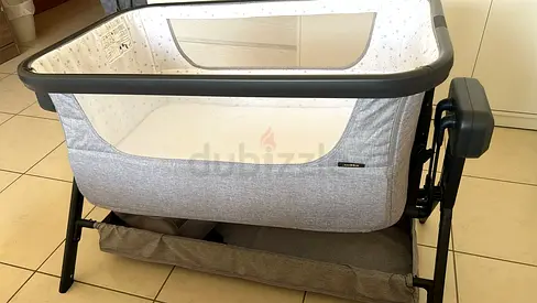 Lightly used bedside bassinet with adjustable attachment - grey
