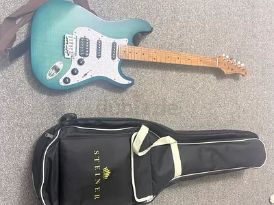 Blue/green electric guitar with gig bag - good condition