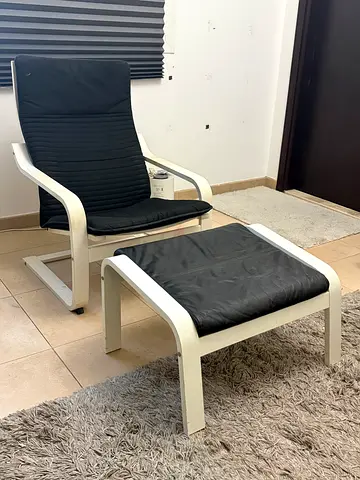 Ikea Armchair with black cushions and footstool