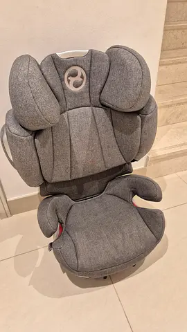 Grey high-back booster car seat in good condition.This is a Cybex Junior car seat. Washed