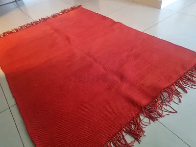 Red woven rug with fringe - good condition