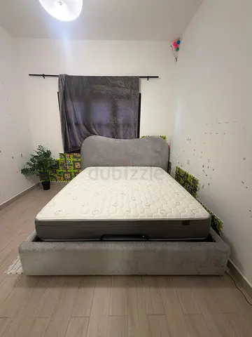 Grey upholstered queen bed frame with mattress included