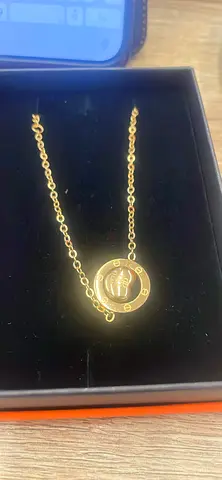 Gold-tone necklace with round engraved pendant - gently used