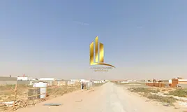 For sale: a prime industrial plot in Al Sajaa S area, with a built-up enclosure, open canopy, two sh