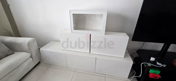 White wall-mounted TV unit with storage cabinets