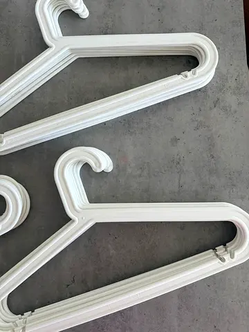Set of white plastic clothes hangers - 66 pieces