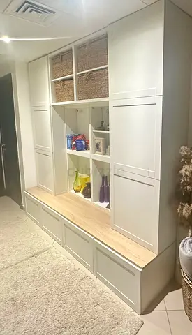Built-in White Storage Bench with Shelves and Cabinets