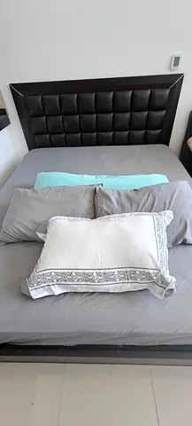Four pillows (one long bolster-style pillow and three standard-sized)