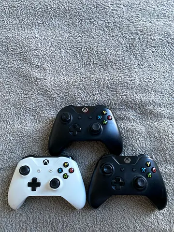 Three Xbox One wireless controllers — 2 black, 1 white (50 aed per controler)