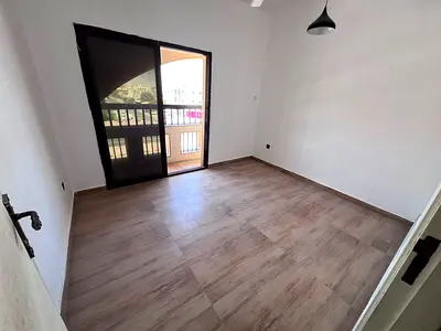 Two bedrooms and a living room, balcony, two bathrooms, split air conditioning, convenient location with easy access to Sharjah and Dubai.