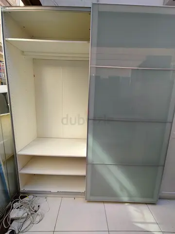White sliding-door wardrobe with shelves — good condition