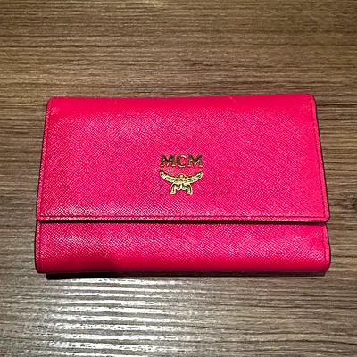 MCM  textured leather wallet finished in a vibrant fuchsia / hot pink colorway.