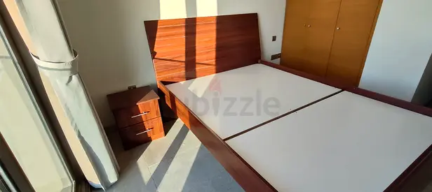 Modern wooden queen bed frame with matching bedside table - good condition