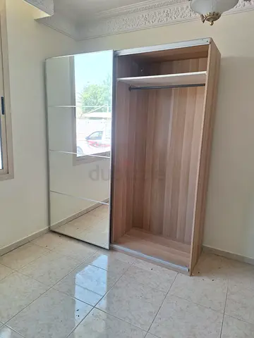Two-door sliding wardrobe with mirrored panel - light wood finish