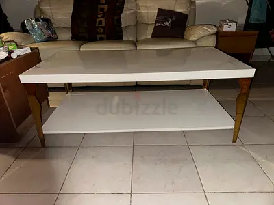 White lacquer coffee table with lower shelf and gold legs - good condition