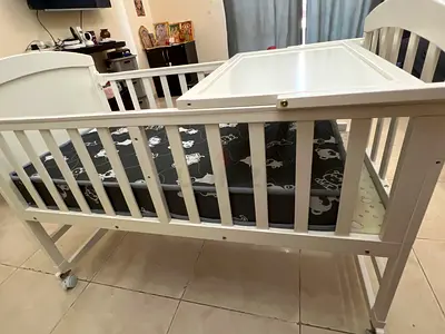 White Wooden Baby Crib with Adjustable Height and Wheels Teknum 7 in 1 usage