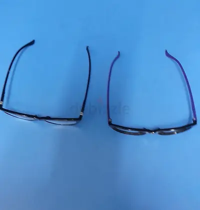 Two pairs of used reading glasses — black frames