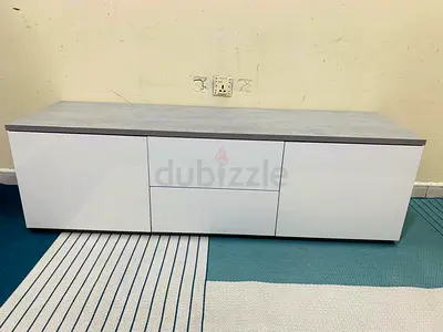 Low white TV cabinet with drawers and concrete-effect top