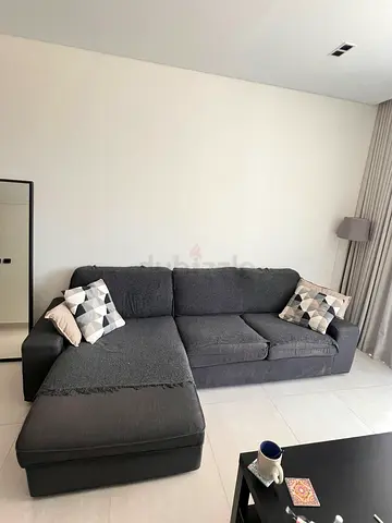 Dark grey L-shaped fabric sofa with chaise (good condition) with coffee table