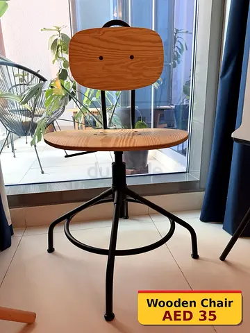 Industrial-style wooden swivel chair with metal base - AED 35