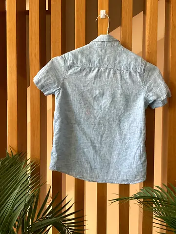 Light blue short-sleeve shirt — gently used, size M