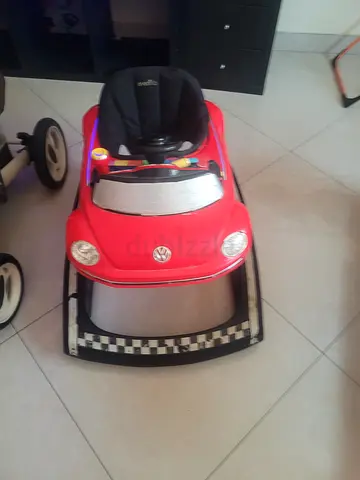Red ride-on baby rocker with detachable wheels (used)
