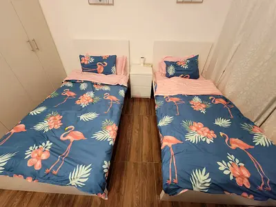 Pair of single beds with floral flamingo bedding set